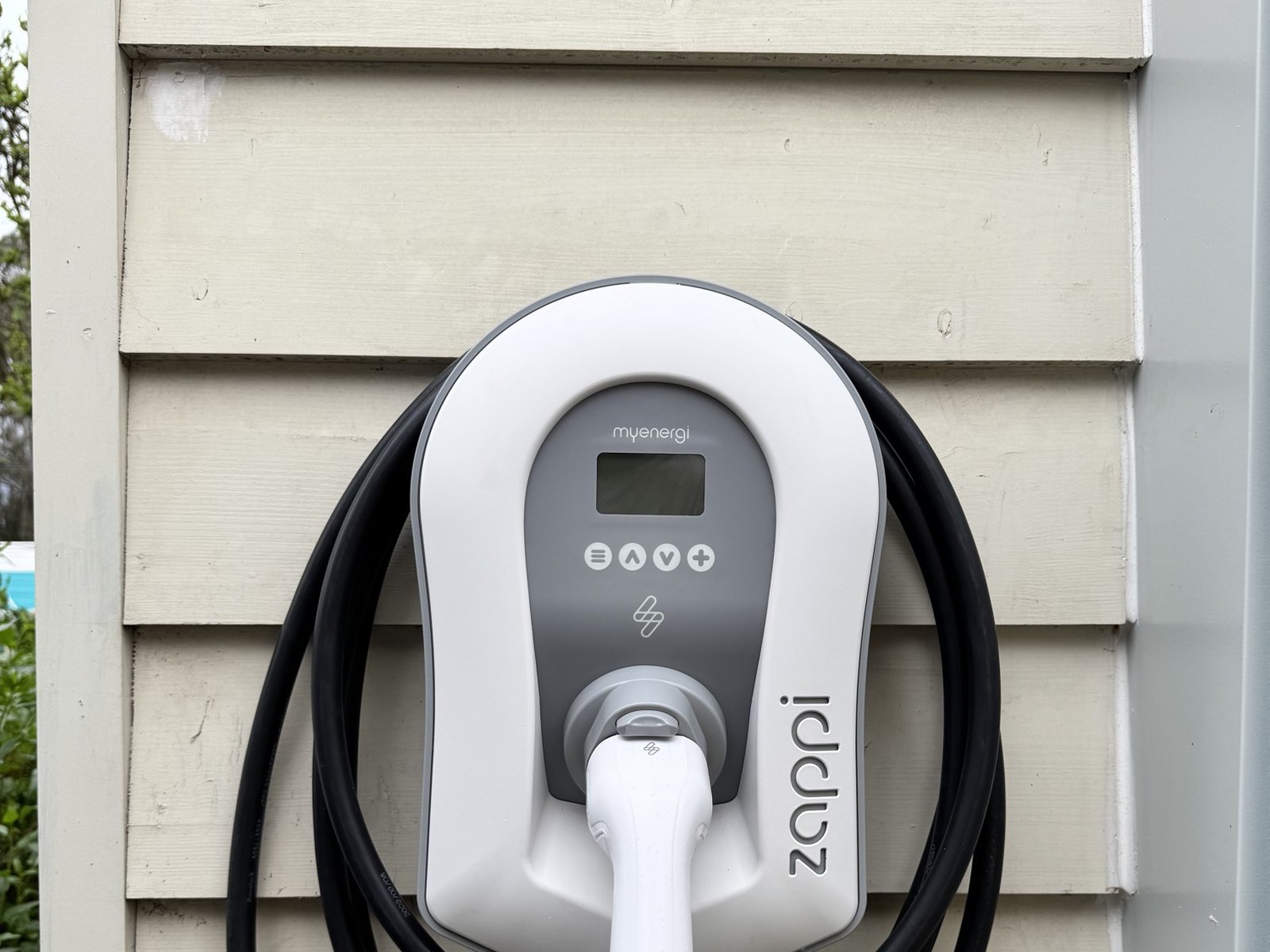 White Zappi charger on weatherboard with the cable coiled